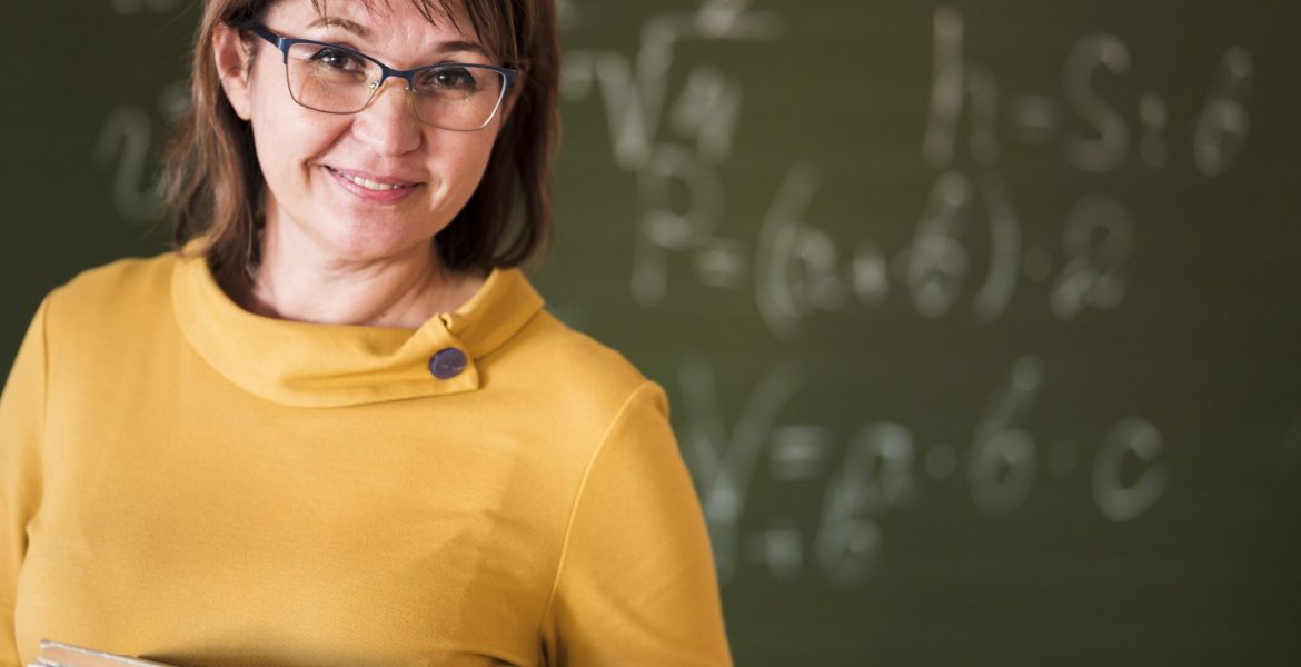 teacher-with-stack-books-claass