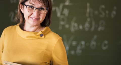 teacher-with-stack-books-claass